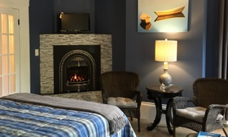 Blue Bedroom with Fireplace, Photo Courtesy of Percy Inn - listing