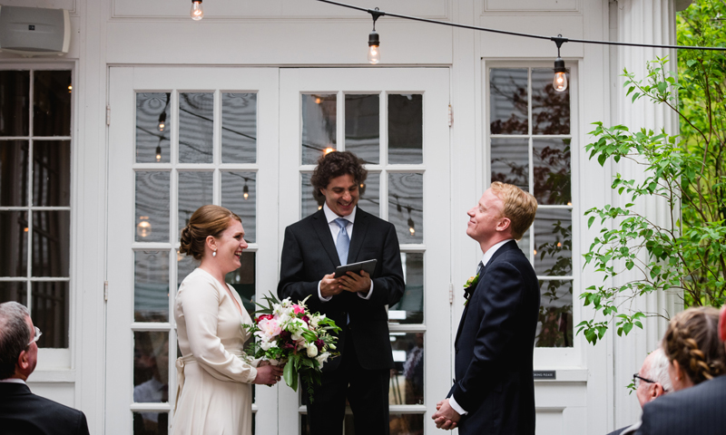 A bride and groom saying their vows on the patio. Photo Credit: Novella Photography
