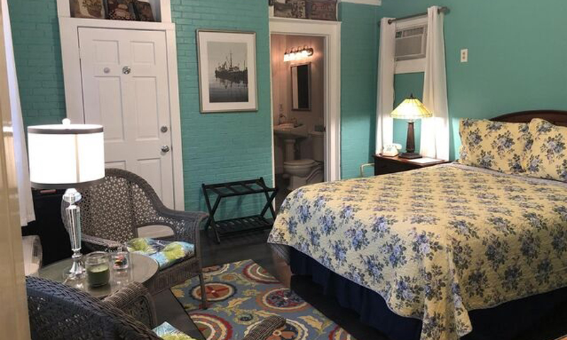 King Bedroom with Chairs, Photo Courtesy of Percy Inn - listing