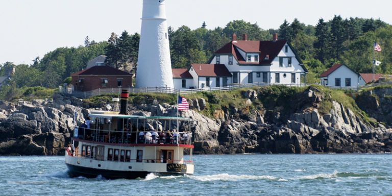 Boat at Portland Head Light. Photo Provided by Portland Discovery Land & Sea Tours