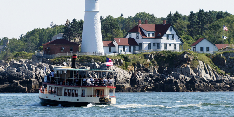 Boat at Portland Head Light. Photo Provided by Portland Discovery Land & Sea Tours