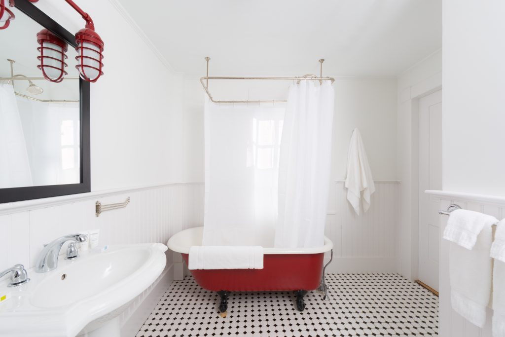 Bathroom with a clawfoot tub. Photo Credit: Rarebrick Photography