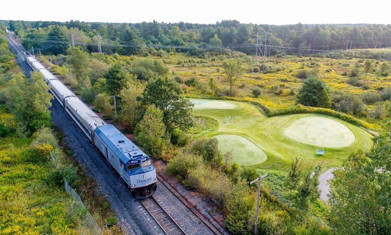 Train by Golf Course. Photo Provided by Amtrak Downeaster