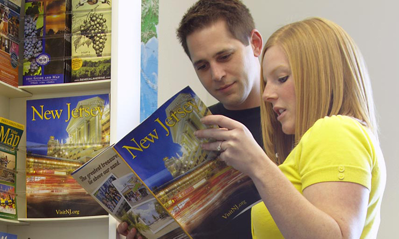 Looking at Brochure. Photo Provided by Getaways On Display, Inc:.