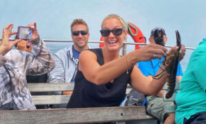 Girl with Lobster. Photo Credit; Experience Maine