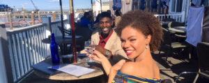Couple at Waterfront Raising a Glass. Photo Credit: Robert Witkowski