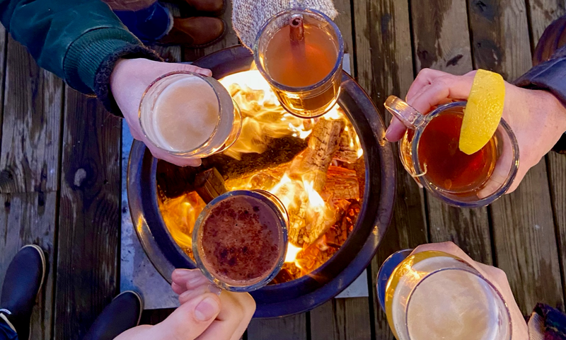 Group Gathering Over A Fire with Drinks, Photo Courtesy of Luke's Lobster