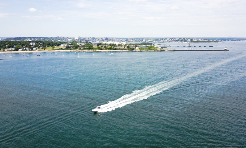 Boat on Casco Bay with City - Photo Credit Capshore Photography Boat on Casco Bay with City - Photo Credit Capshore Photography