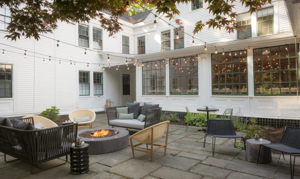 Outdoor patio with a firepit and seating area. Photo Credit: Rarebrick Photography