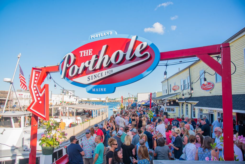 The Porthole sign over crowd on deck, Photo Credits: The Porthole