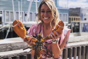 Girl with Lobster. Photo Provided by Boone's Fish House & Oyster Room