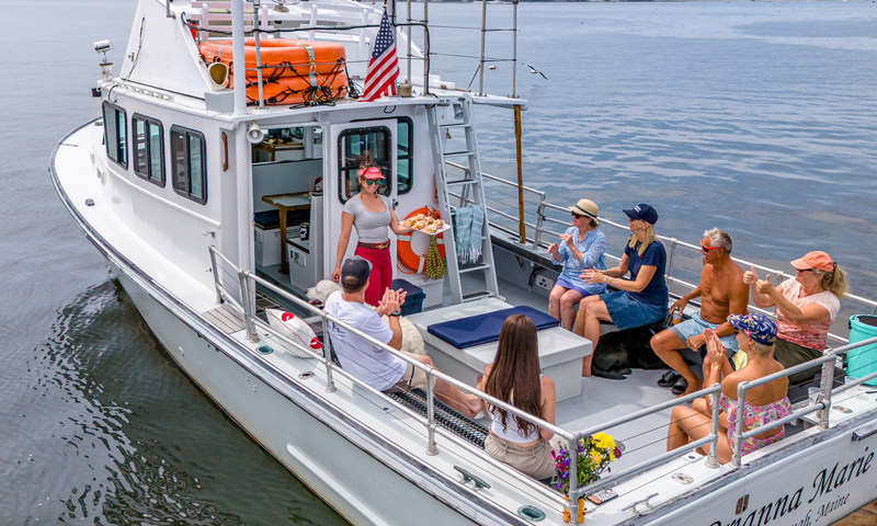 Group Eating on Boat Charter. Photo Credit: PGM Photography