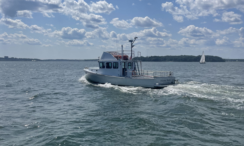 Boat Cruising over Casco Bay. Photo Credit: Owen Johnson