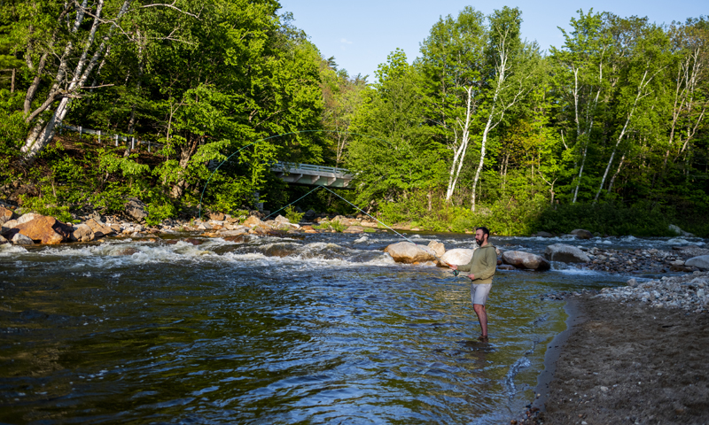 Man fishing across river, Photo credit to Capshore Photography Man fishing across river, Photo credit to Capshore Photography