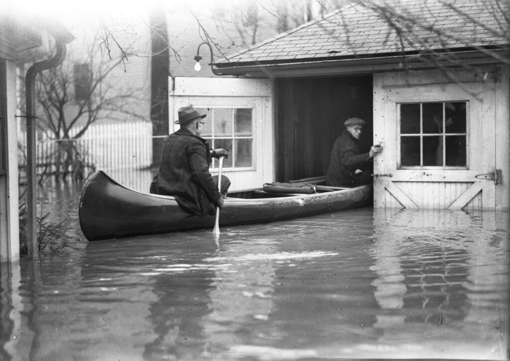 Two men rowing into flooded garage 1936_ Photo courtesy of Maine Historical Society_MaineToday Media