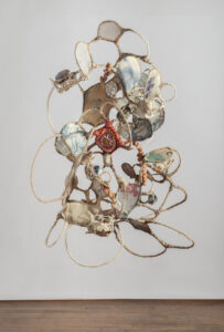 Jodi Corella, A Figment of, 2024, Wire armature, cheesecloth, tea stained rope, family photos printed on silk, assorted textiles and yarn, 57 x 45 x 40 inches.