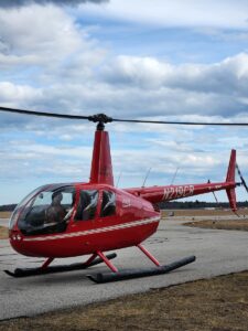 Pilot in Helicopter. Photo Credit: Pine Tree Helicopters