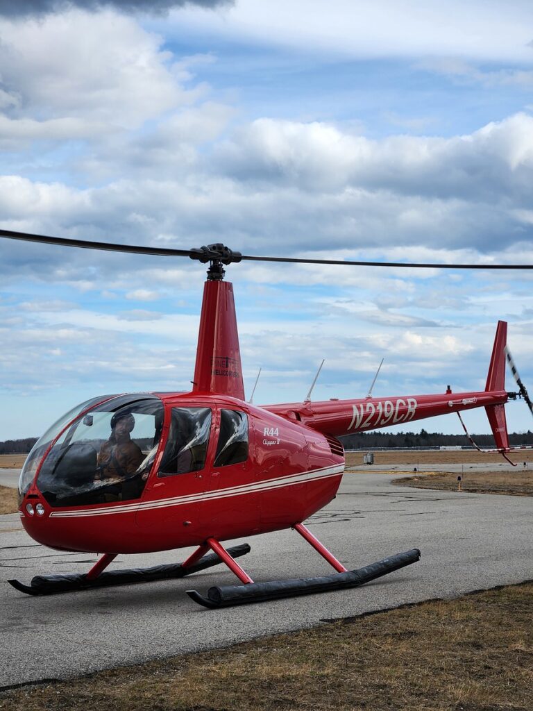 Pilot in Helicopter. Photo Credit: Pine Tree Helicopters