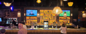 Woman standing at bar; Photo Credit: Lauren Peters at Visit Portland