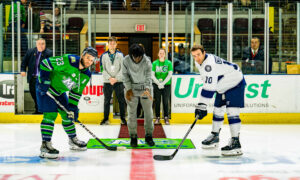 Posing for the puck drop before a hockey game; Photo Credit: Maine Mariners Photography Team