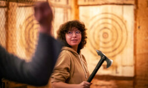 Woman about to throw axe; Photo Credit: Nate Davis