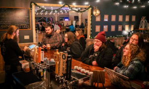 People enjoying Axe Pit bar; Photo Credit: Nate Davis