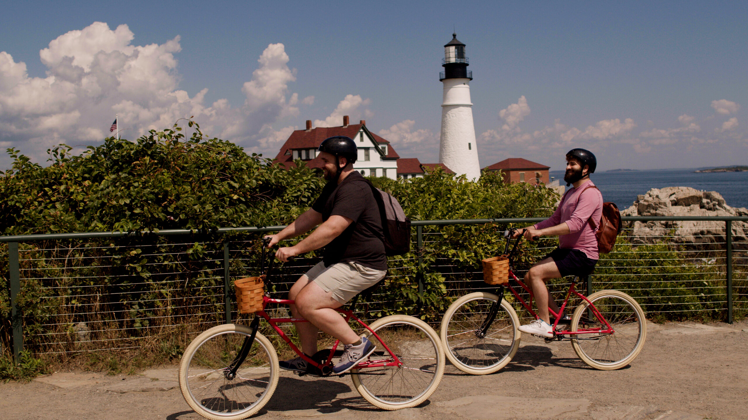 Couple on bikes in front of Portland Head Light, Photo Credit: Knack Factory Couple on bikes in front of Portland Head Light, Photo Credit: Knack Factory