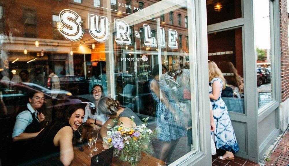 Exterior of Sur Lie with people in dining room (taken in 2019) - Photo courtesy of Wine Wise Events Exterior of Sur Lie with people in dining room (taken in 2019) - Photo courtesy of Wine Wise Events